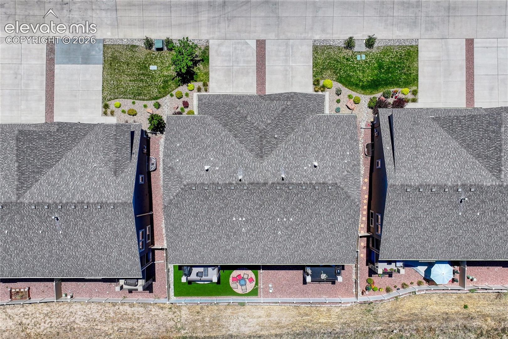 Aerial views showcase the thoughtful property layout, outdoor living spaces, landscaping, and peaceful community surroundings.
