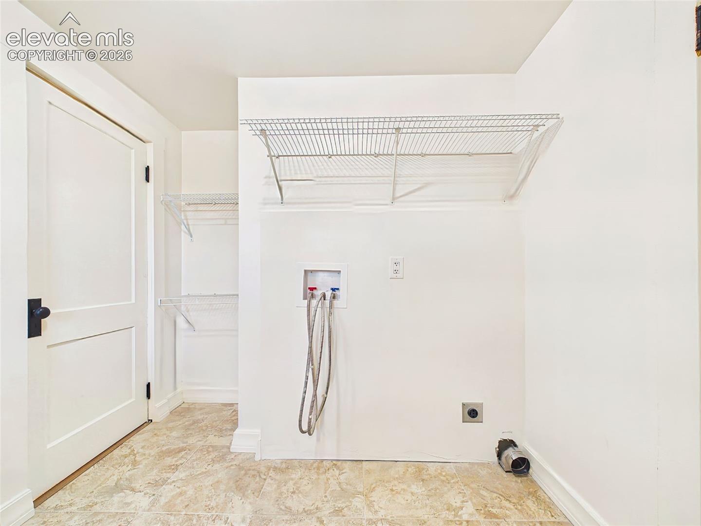 Laundry Area – Laundry area is thoughtfully integrated into the full bathroom and includes tile flooring, additional shelving, and space to keep household essentials organized.