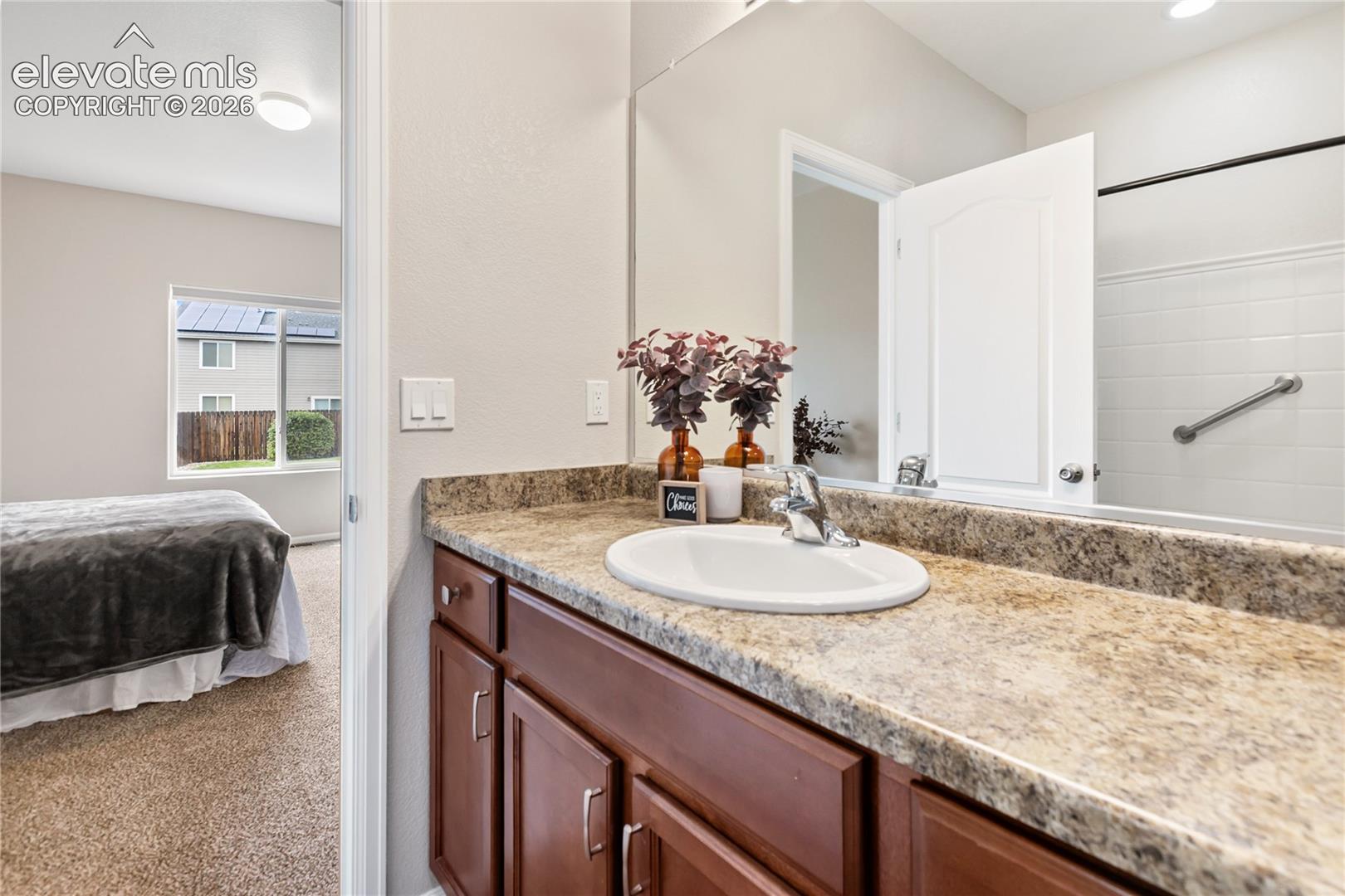 Primary bathroom - spacious countertop and oversized tub/shower