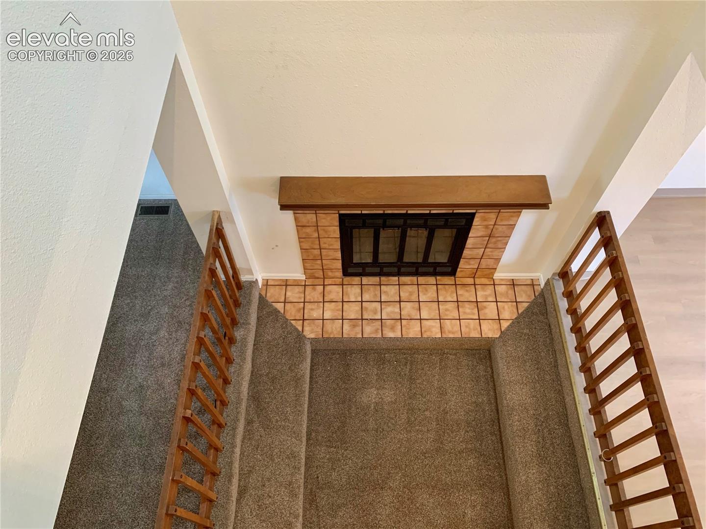 Upstairs view of fireplace in living room.