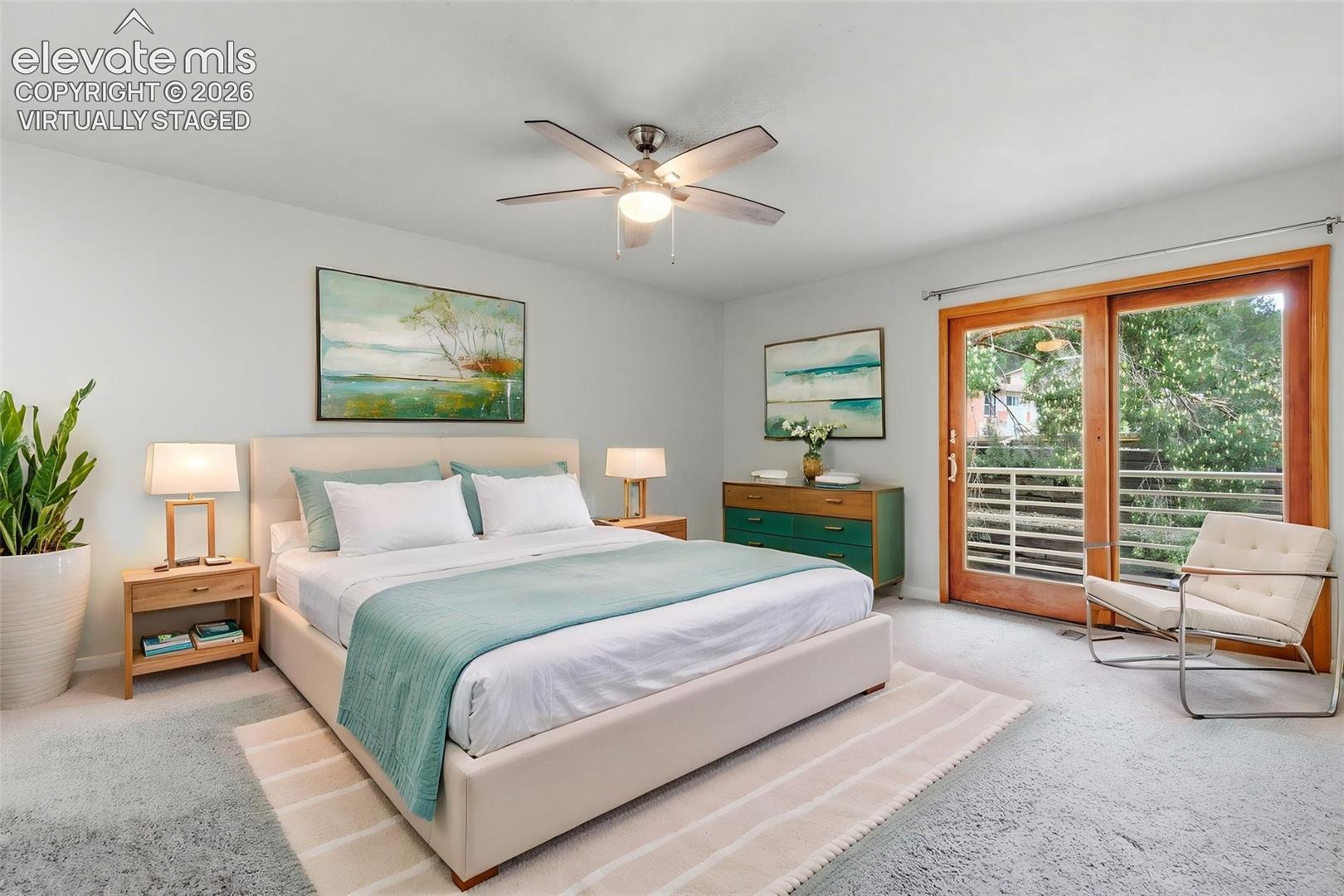 Virtually Staged -
Light-filled primary featuring light gray carpeting and a ceiling fan