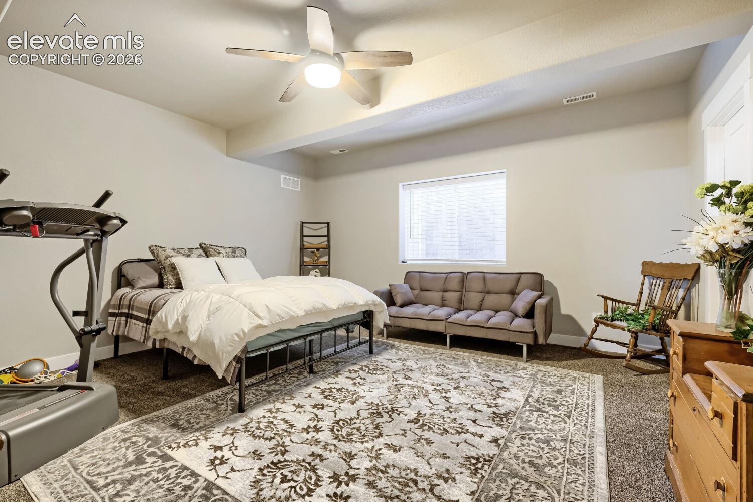 Recessed lighting and ceiling fan overhead, neutral wall tones, and carpet flooring