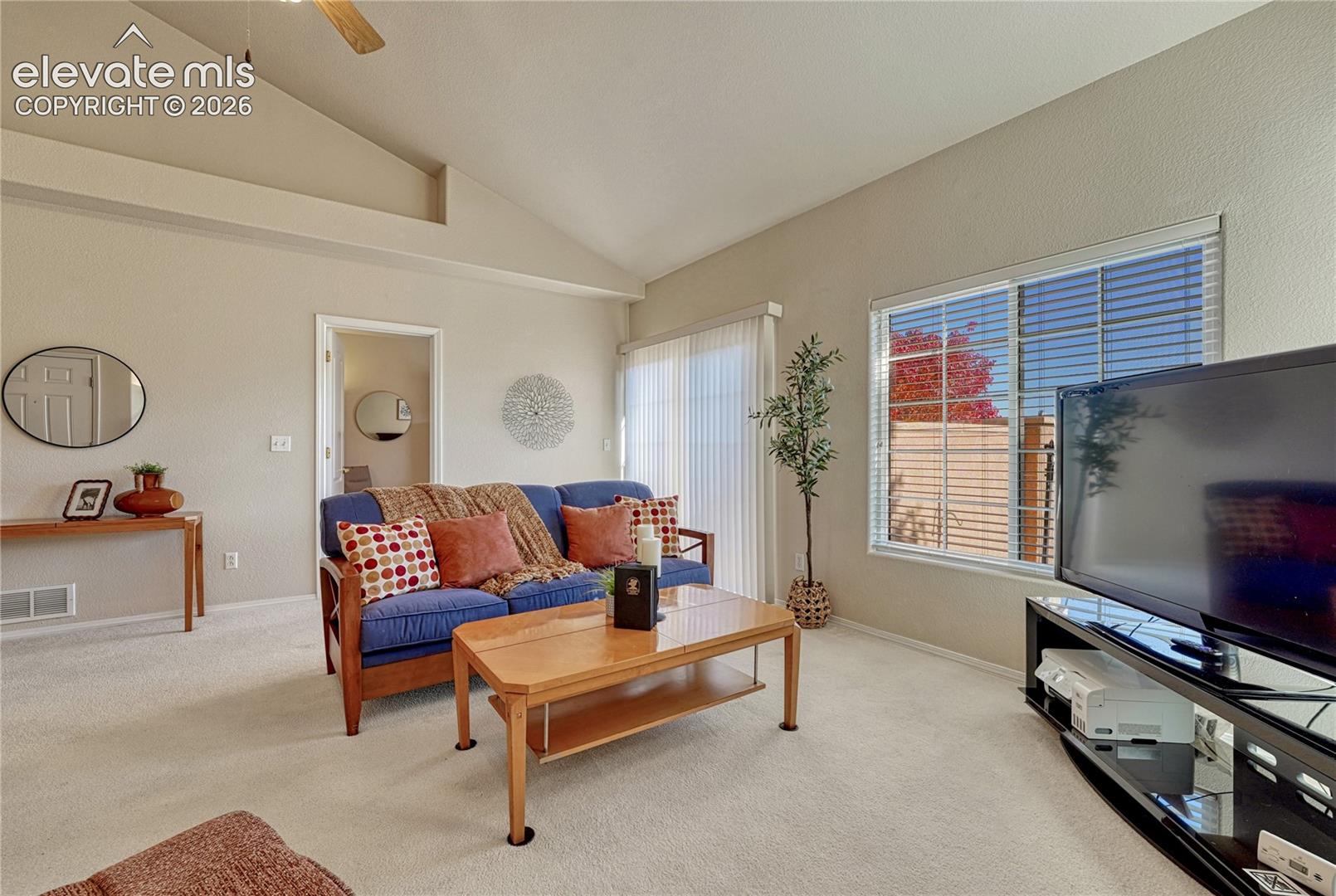 The expansive living room offers a bright, versatile layout designed for effortless entertaining or quiet relaxation
