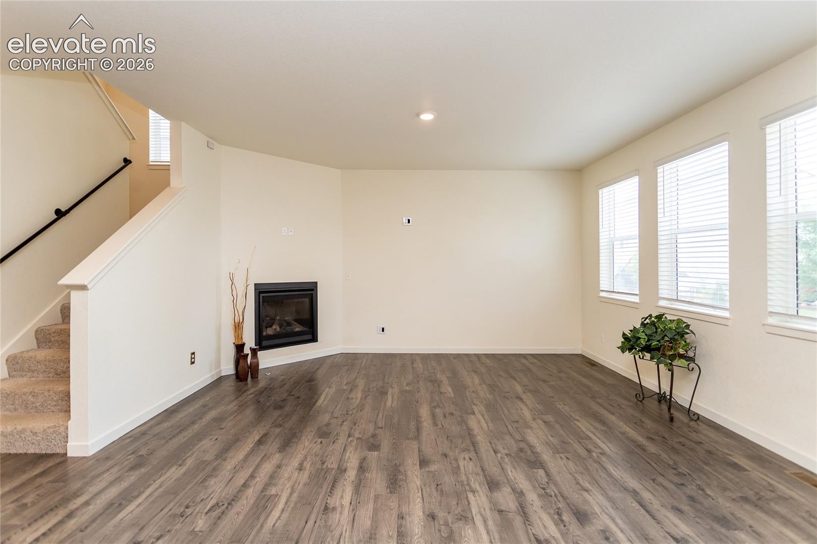 Spacious living room is highlighted by a cozy fireplace.