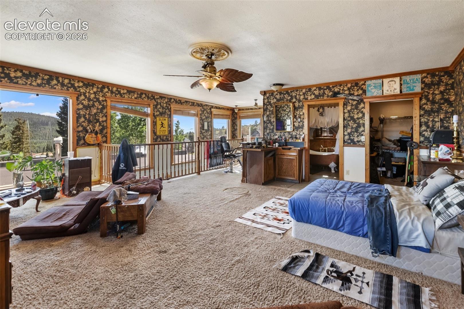 in this photo, which is looking north east to south west you can see the designer sink for the bath, the large closet for the space and again the railing over the staircase. proceeding west you can exit onto the wood deck and decsend the stairs into the yard.