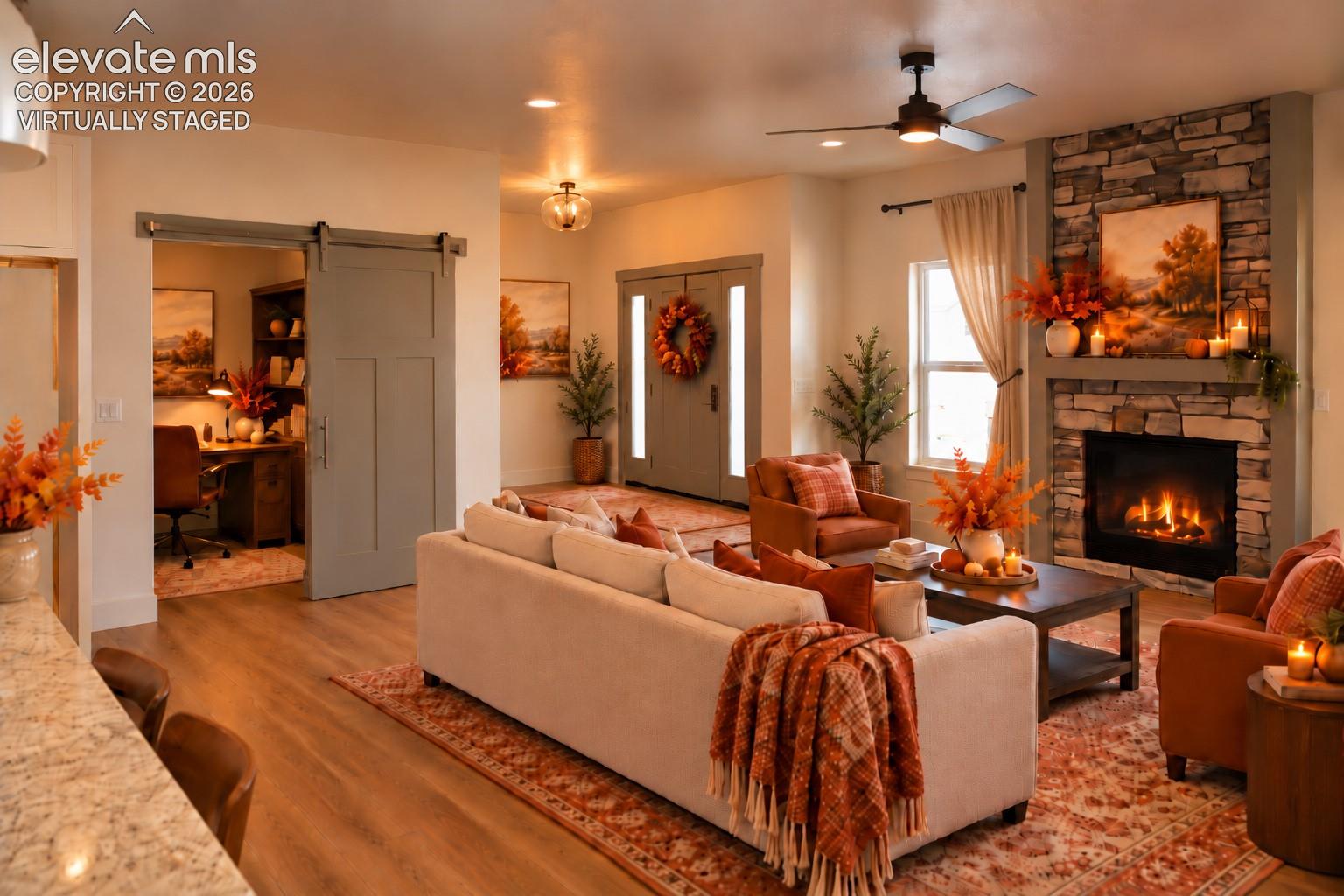 Virtually staged Stone-clad fireplace with mantel, wood-finish flooring, recessed lighting, and a ceiling fan