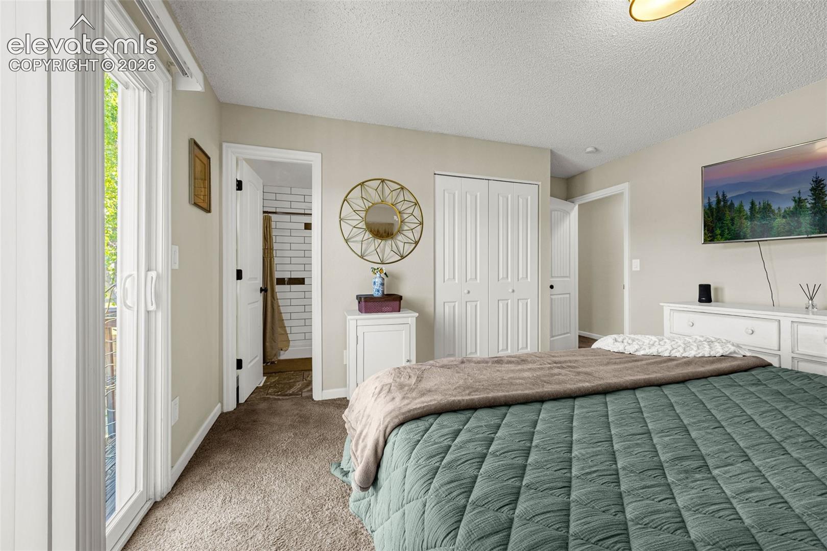 Sliding glass door, wall-to-wall carpeting, and double-door closet