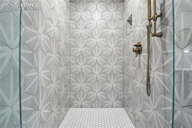 Full bath featuring a tile shower