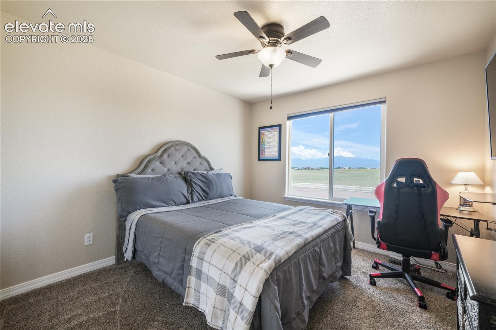 Upper Level Bedroom with Ceiling Fan and View.