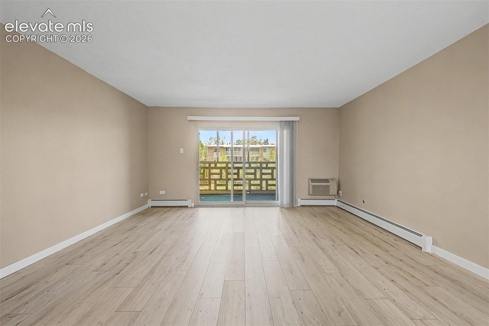 Spacious interior featuring wood-finish flooring and neutral wall tones