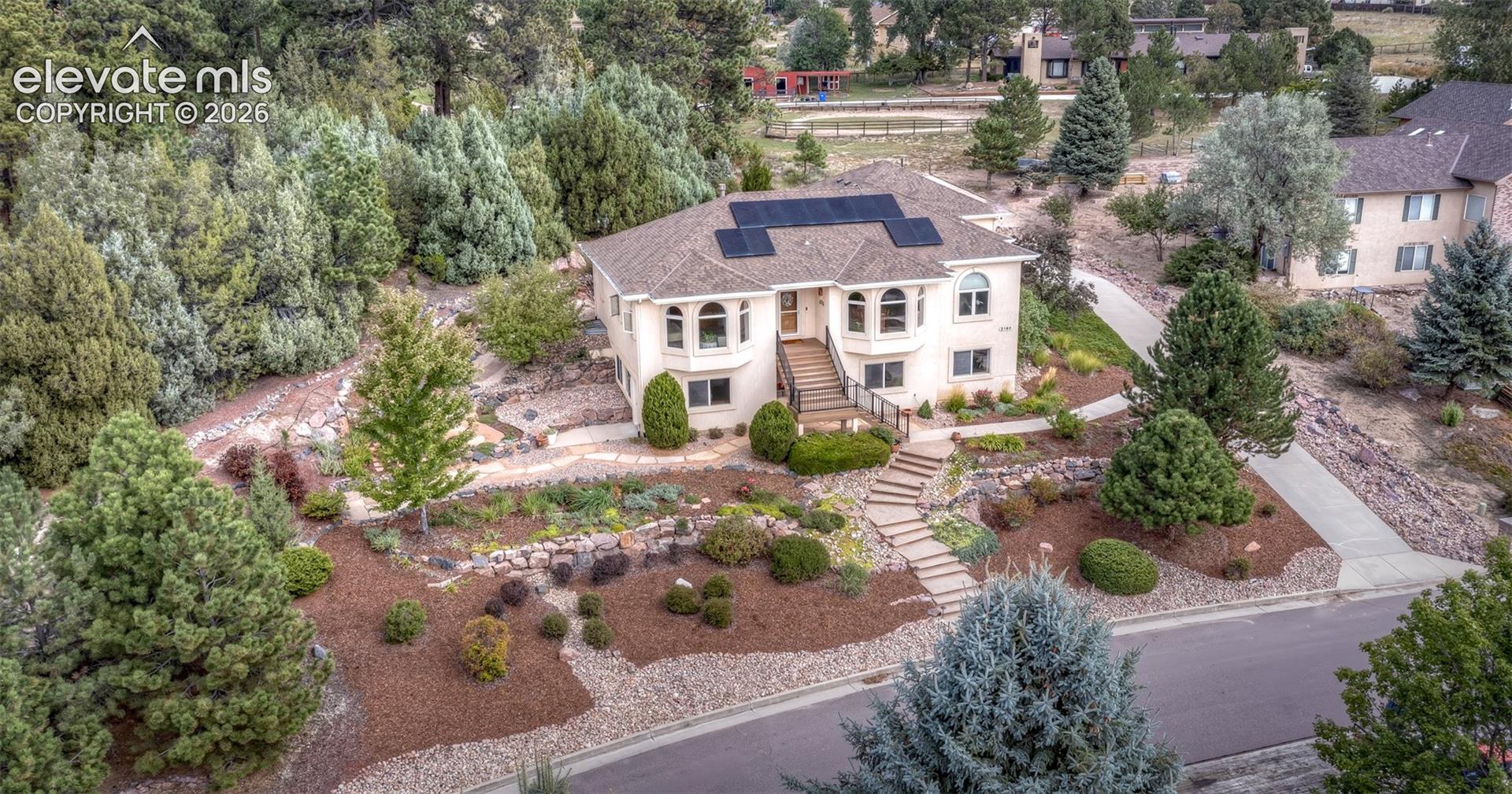 This very stately home offers beautiful landscaping, paver walkways, trees and so much privacy!