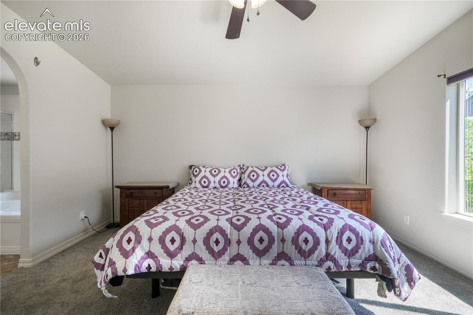 Main level primary bedroom with ensuite 5 piece bathroom with granite counters, large walk in closet and new carpet