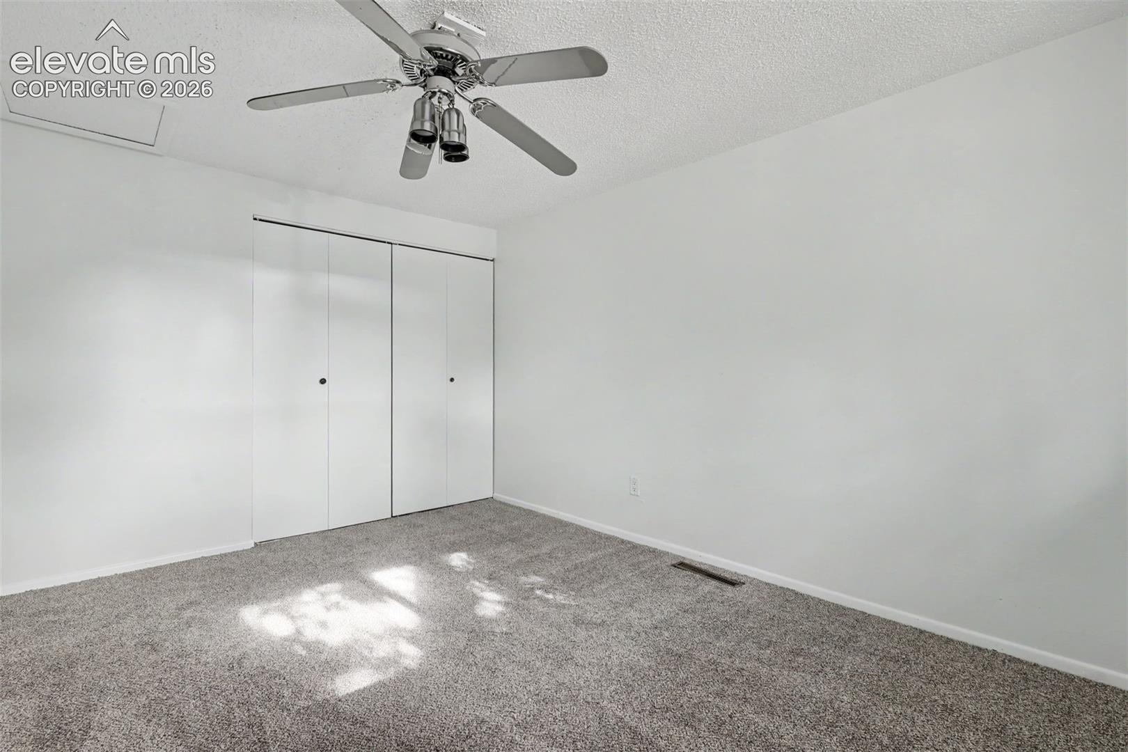 Secondary bedroom with functional layout and closet storage.