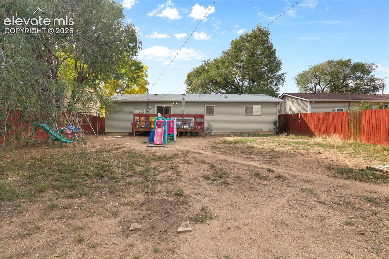 Fully fenced in back yard with gate access to fenced front yard and the back garage entrance