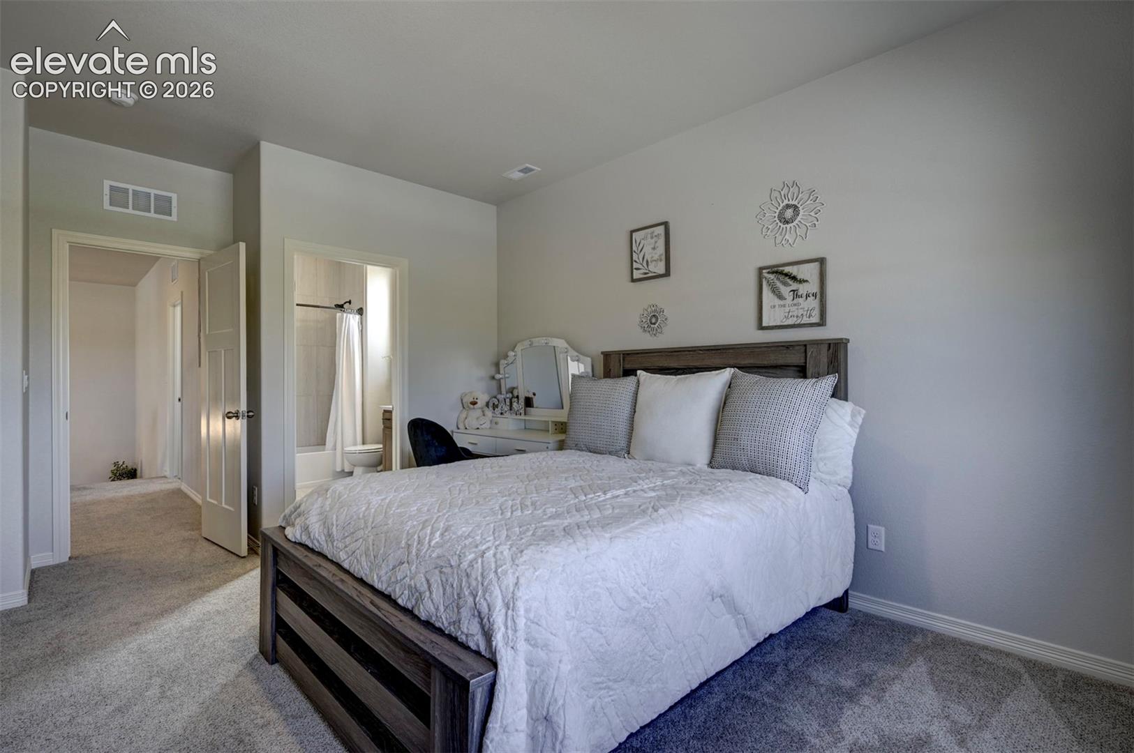 Bedroom featuring light gray wall paint and gray carpet flooring