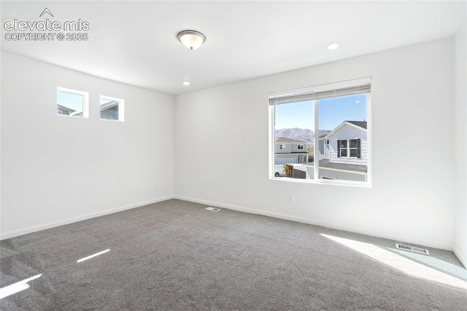 White walls with recessed lighting and a central flush mount fixture
*photos of a model home*