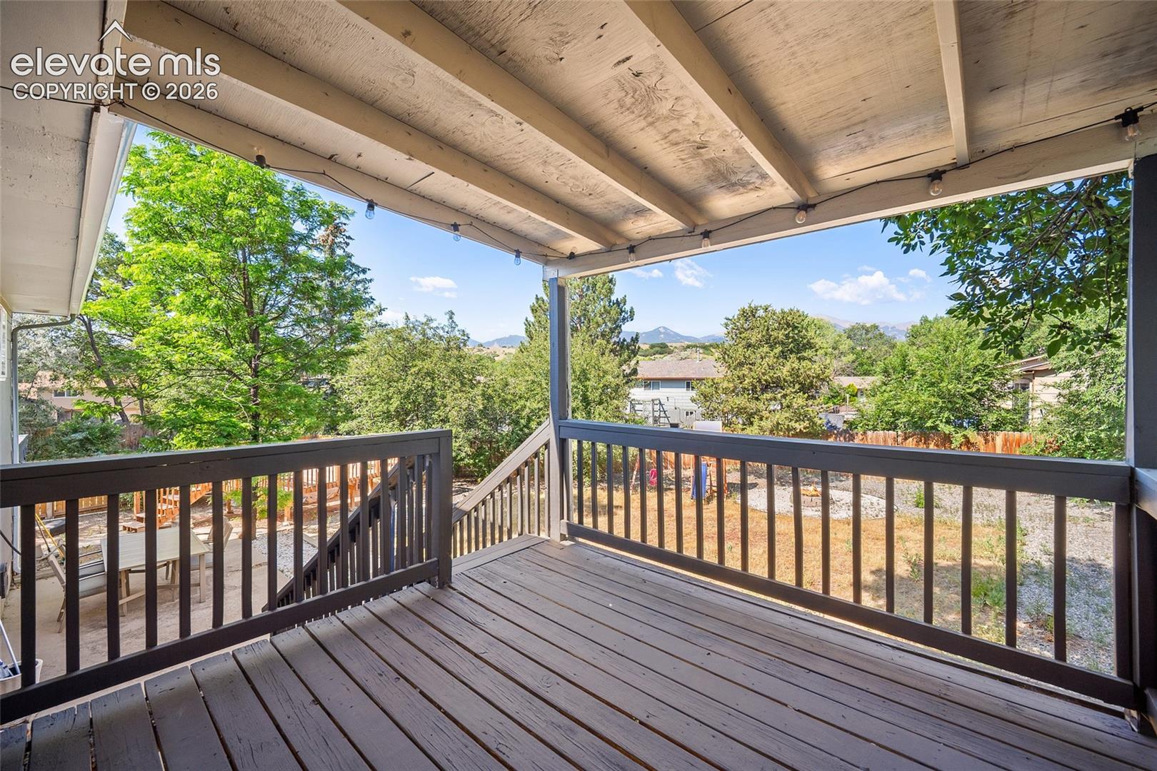 Covered deck with views of mature trees.