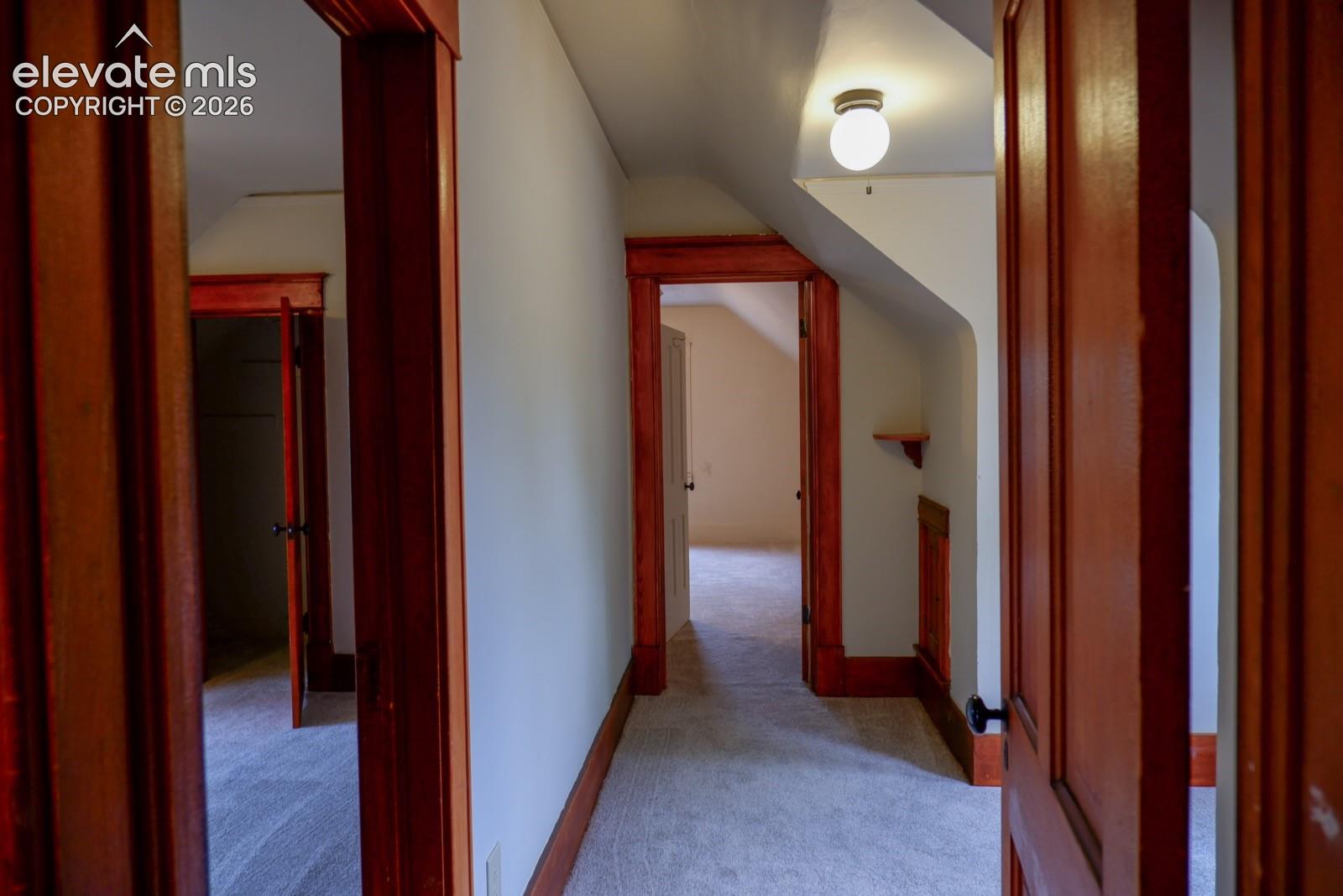 upstairs hallway to rooms, bathroom, and sunlit reading nook