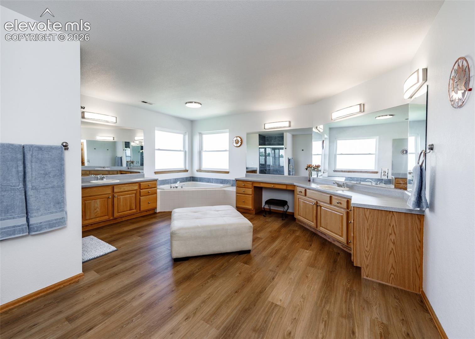 Dual vanity with wood-finish cabinetry and light countertops
