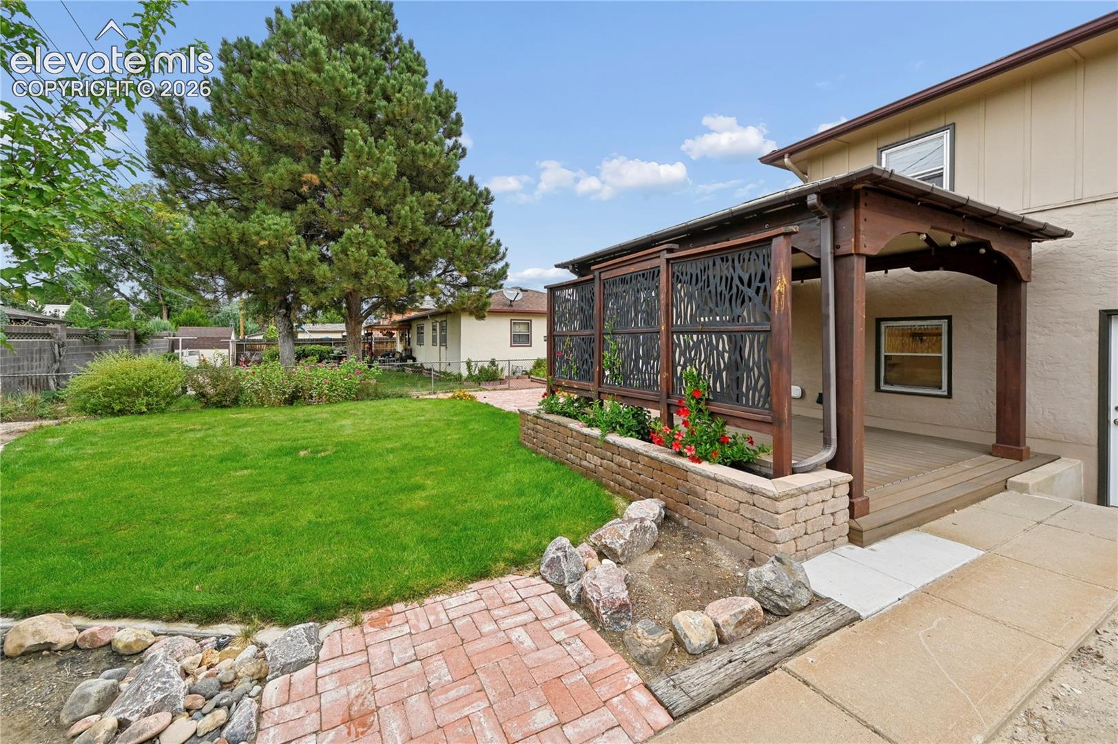 Beautifully Landscaped Backyard with Covered Deck
