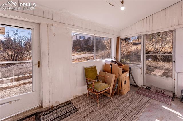 Sunroom / solarium featuring lofted ceiling