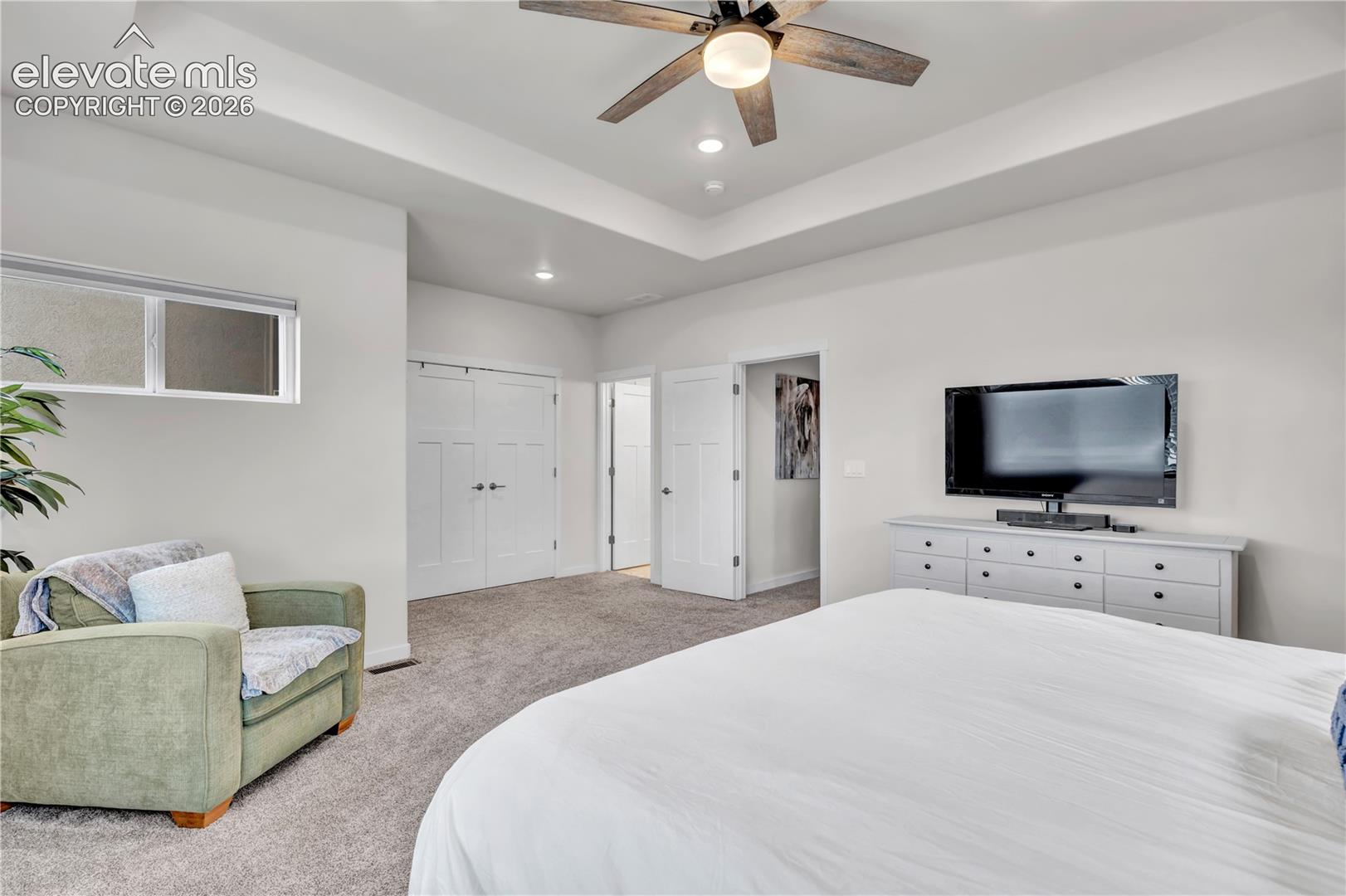 Tray ceiling with recessed lighting and a ceiling fan