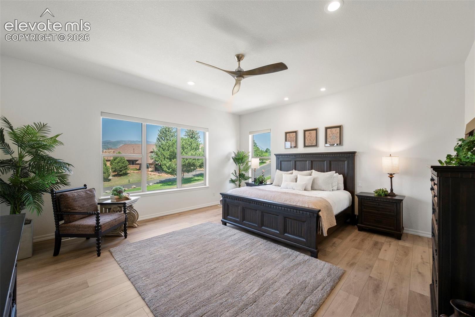 Recessed lighting, beautiful flooring, and multiple windows providing ample natural light and spectacular Pikes Peak views