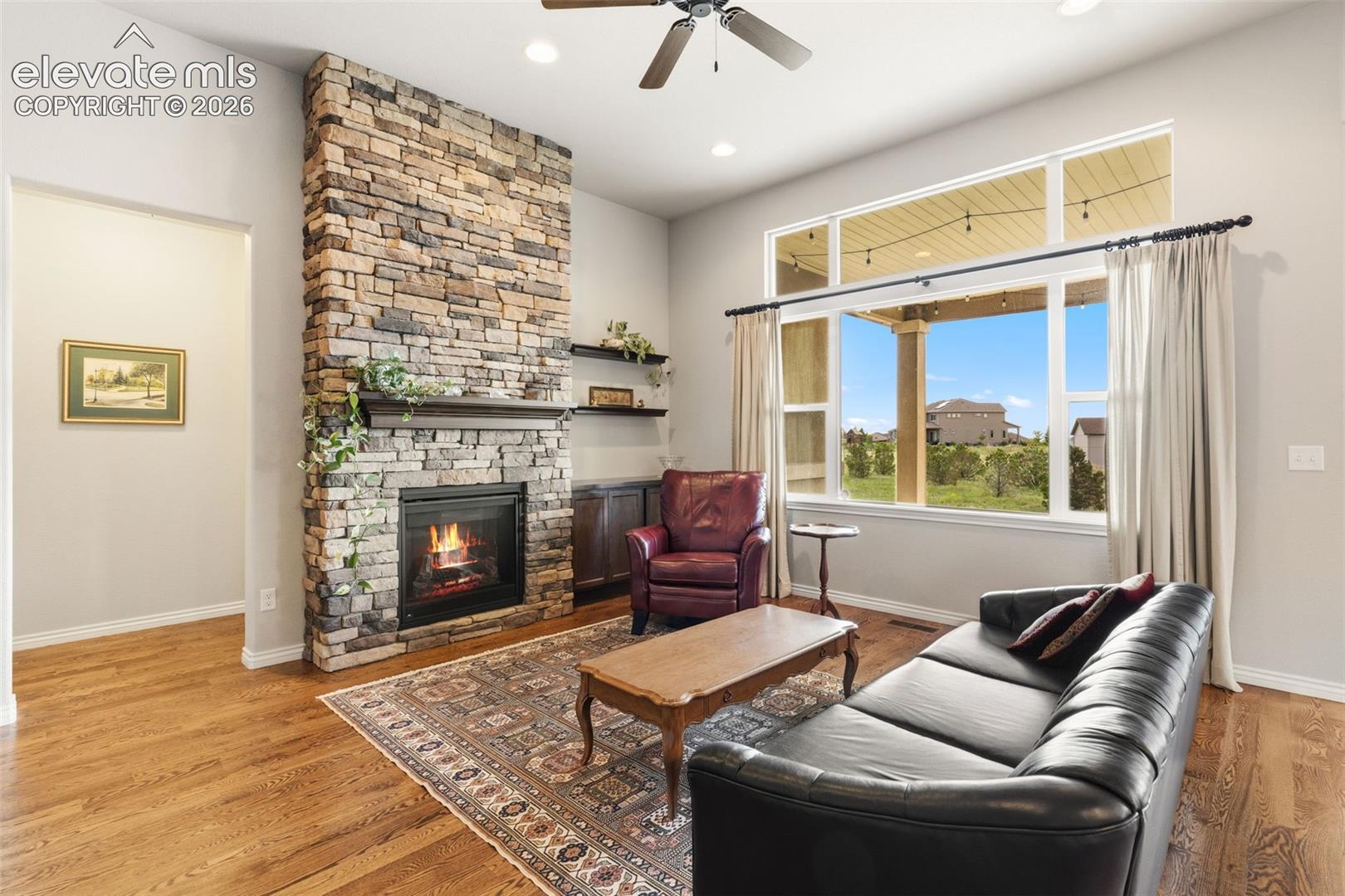 Living room with view across back of property and stunning brick fireplace