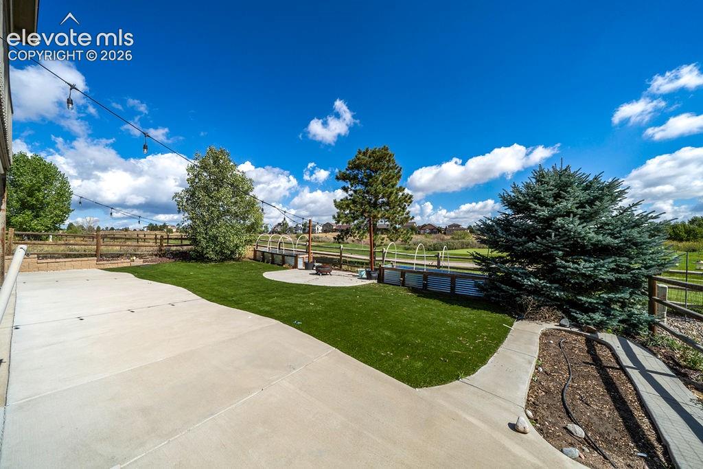 Expansive concrete patio with integrated artificial turf