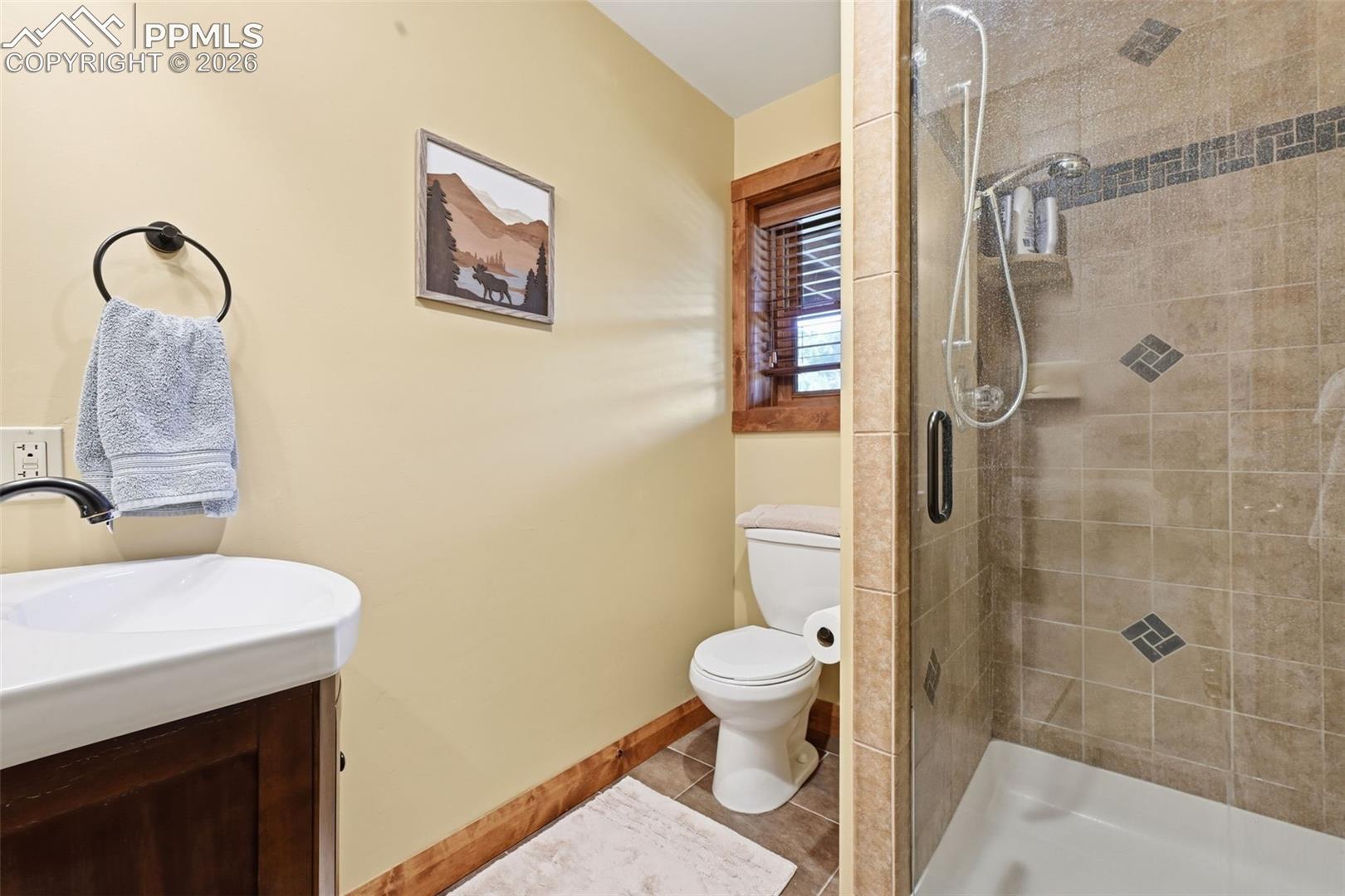 Basement 3/4 bathroom provides a glass enclosed shower. 