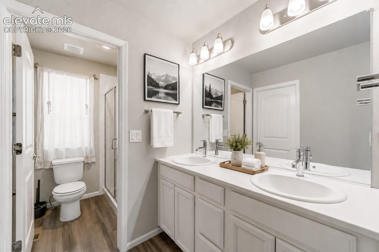 Primary bath with dual-sink vanity and ample counter space.