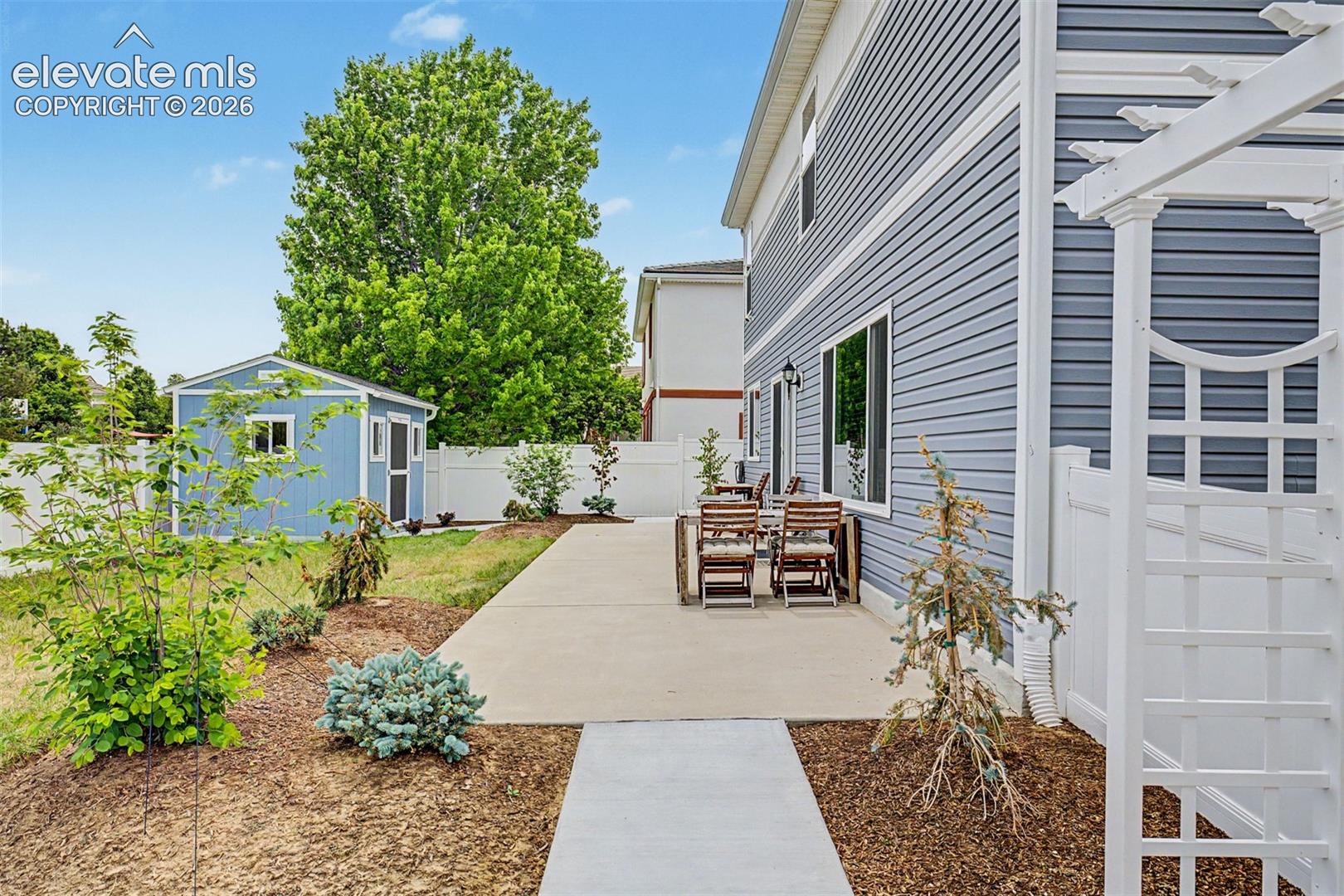 The back patio's direct access through the sliding door makes indoor-outdoor living feel completely natural, a seamless extension of the home's generous entertaining spaces.
