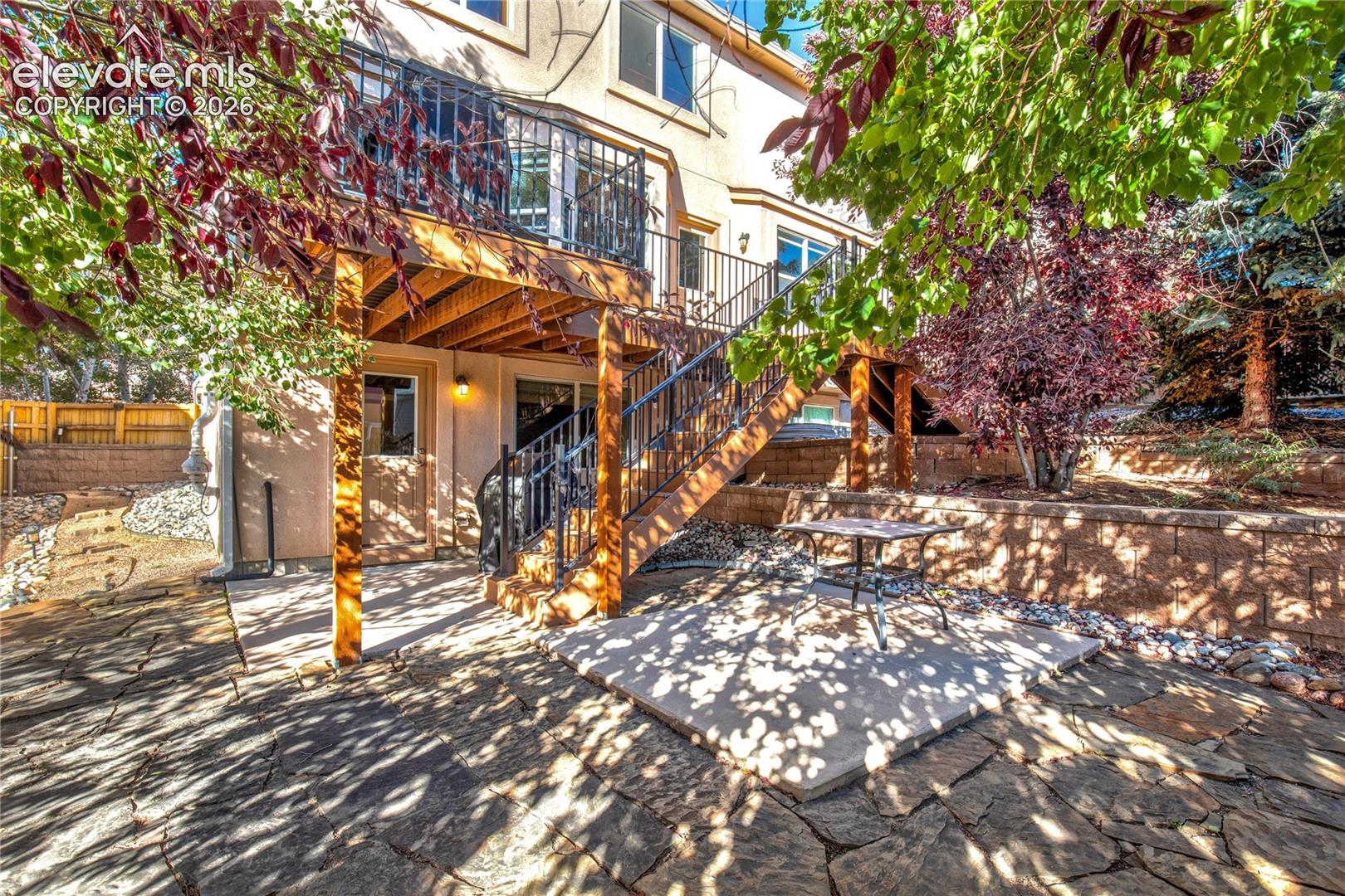 Mature trees, established landscaping + a flagstone patio create an inviting backyard setting for outdoor dining, relaxing + enjoying Colorado's changing seasons.