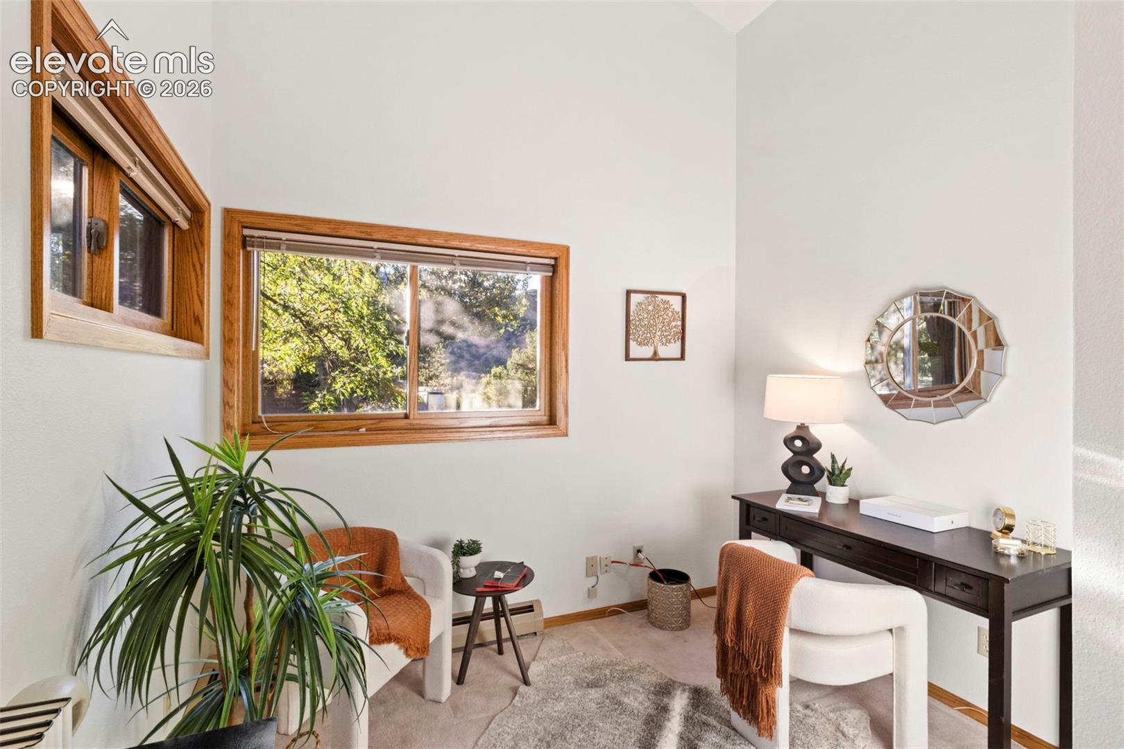 Vaulted ceilings, expansive window openings, and natural wood trim framing
