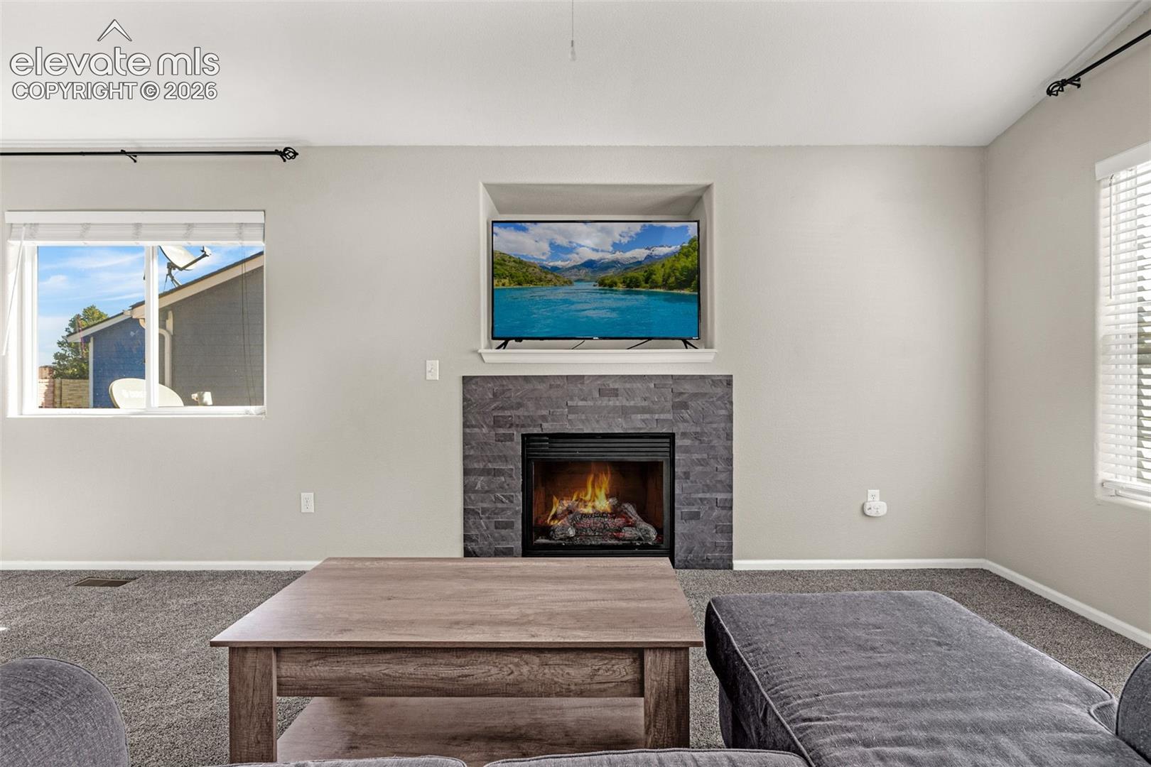 Built-in media niche above a stone-clad fireplace