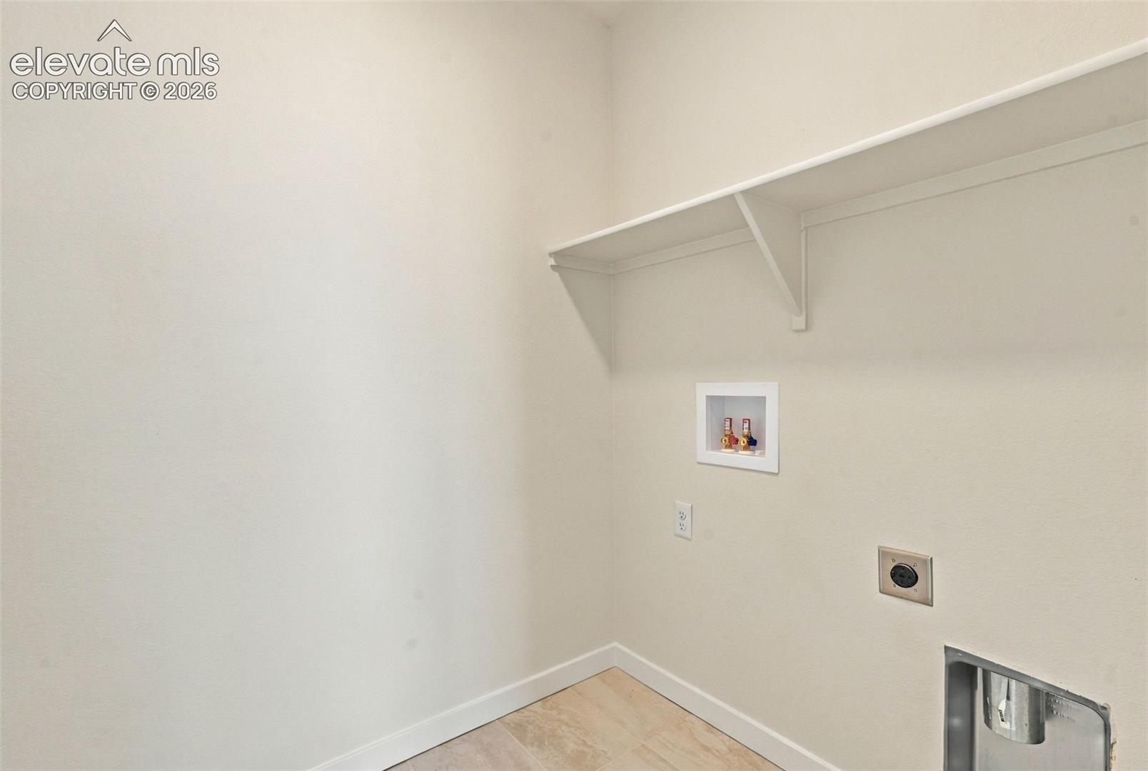 Built-in shelving, tile flooring, and appliance hookups