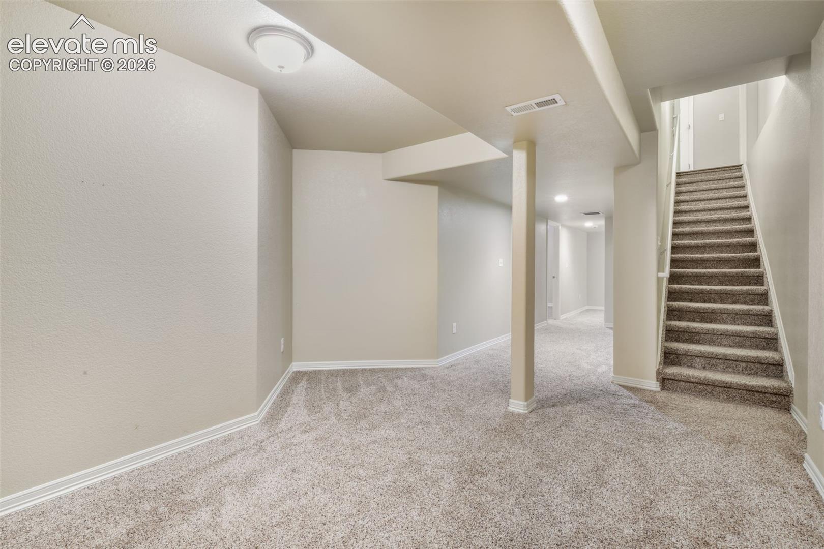 Lower level with recessed lighting, neutral carpet, and painted walls