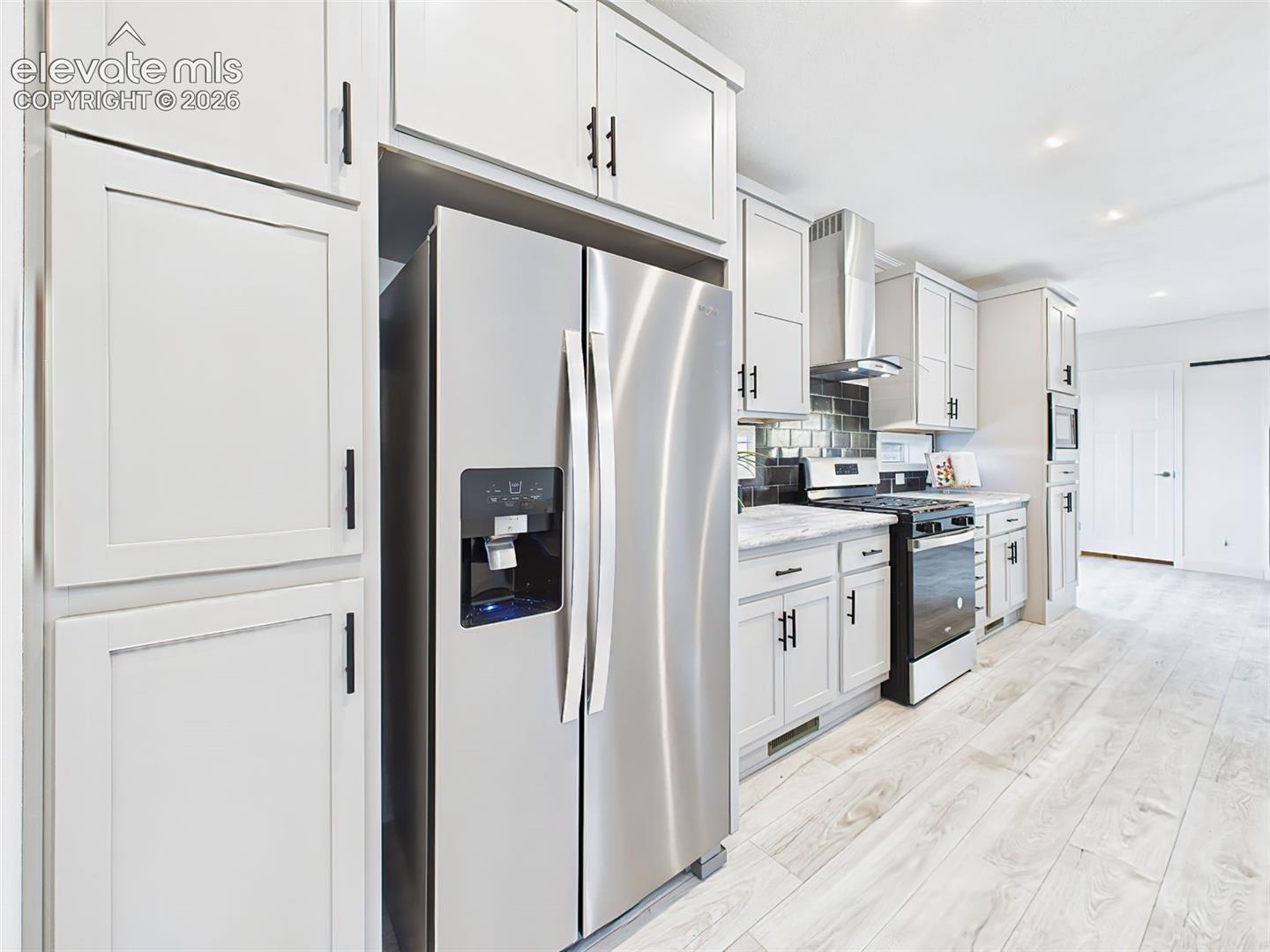 Abundant cabinet storage, built-in microwave, and refrigerator with ice/water dispenser.