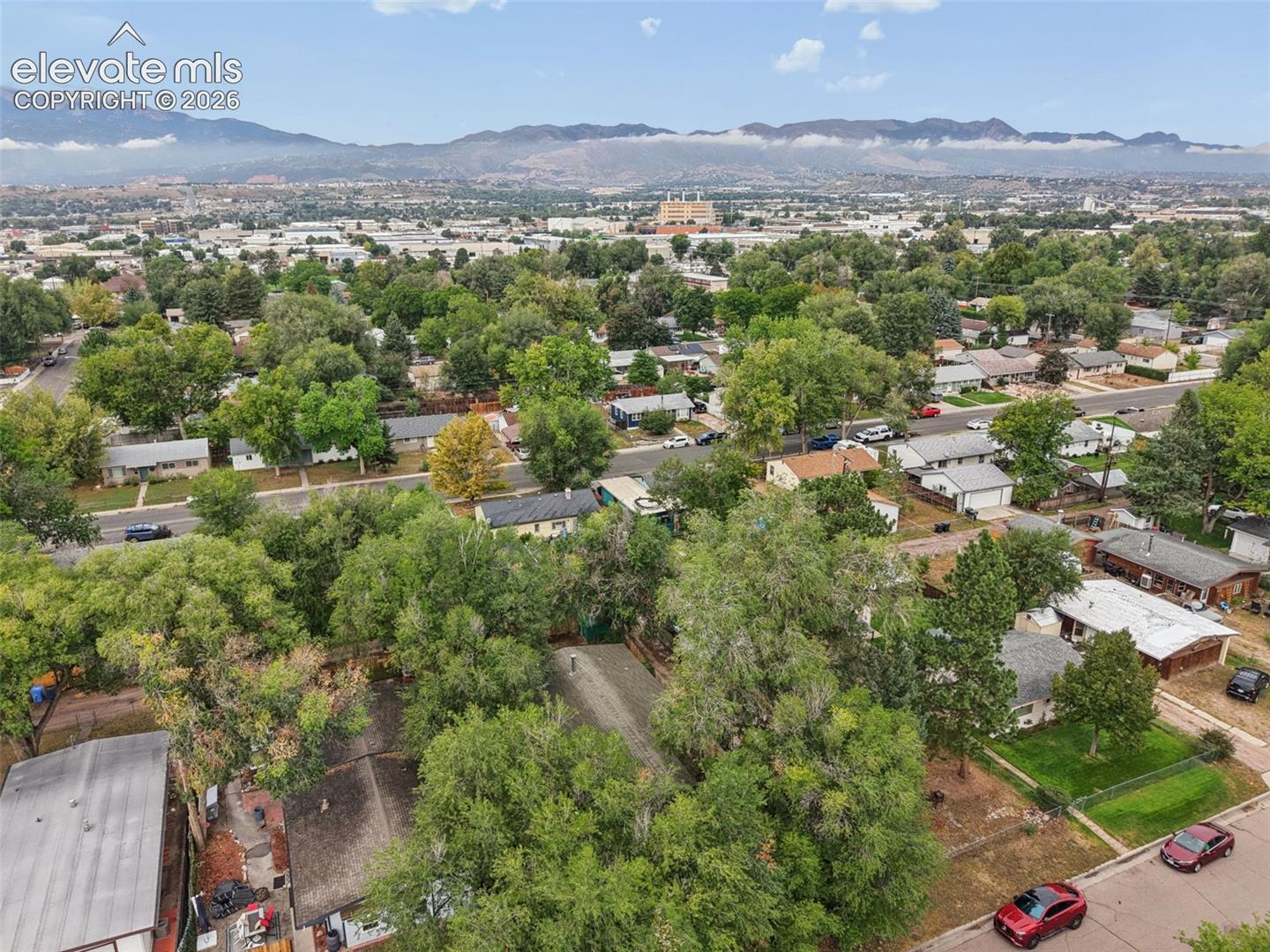 Expansive community featuring mature trees and distant mountains