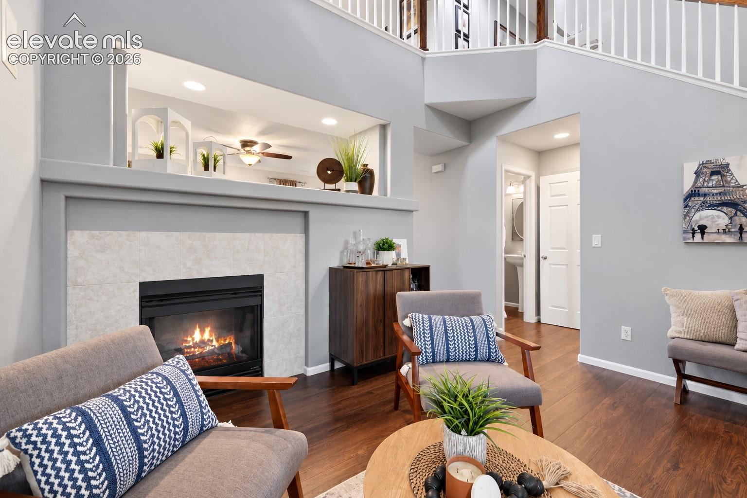 A cozy fireplace anchors this inviting conversation area without sacrificing the home's open feel.