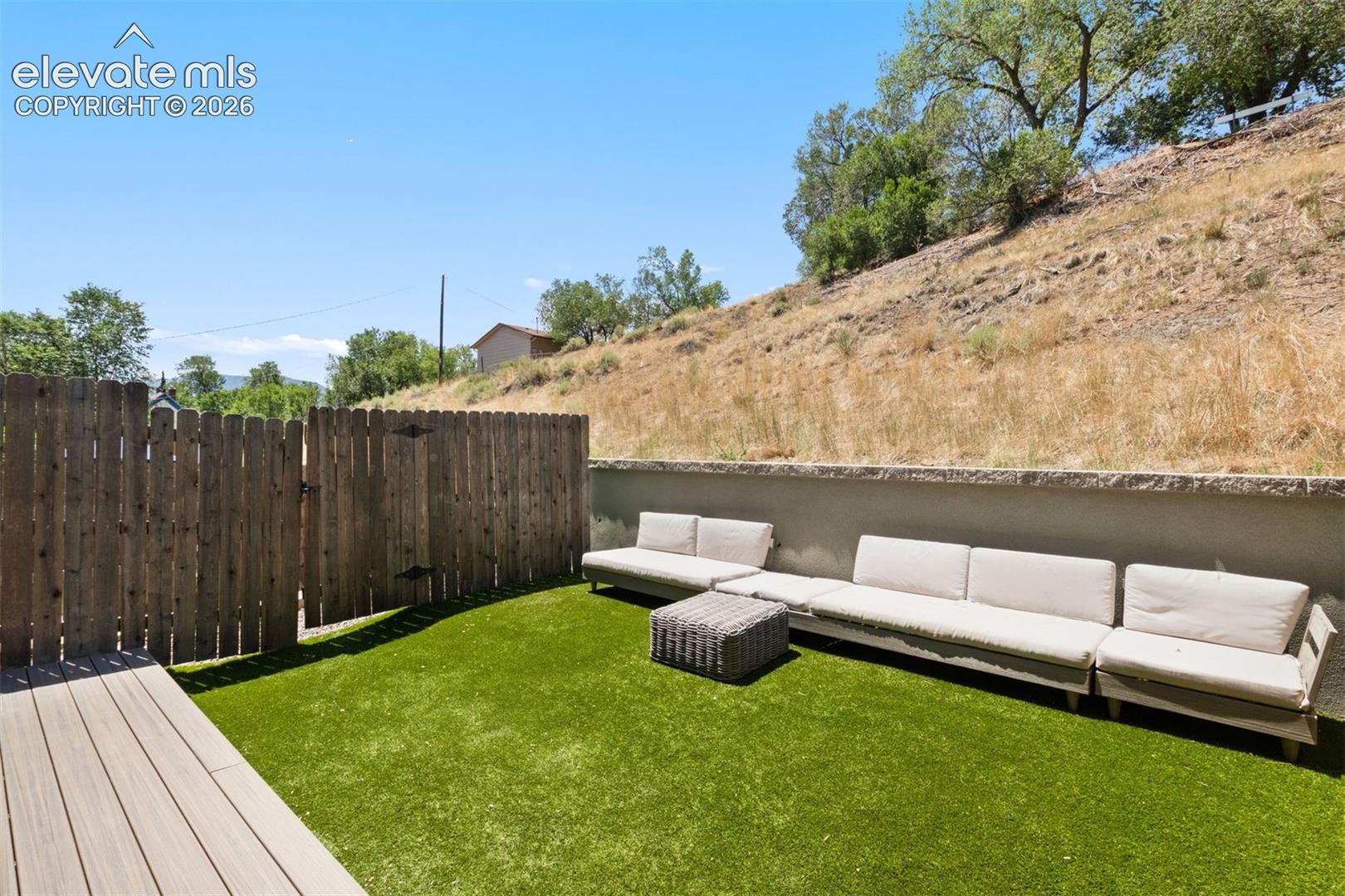 Patio with included furniture and turf yard