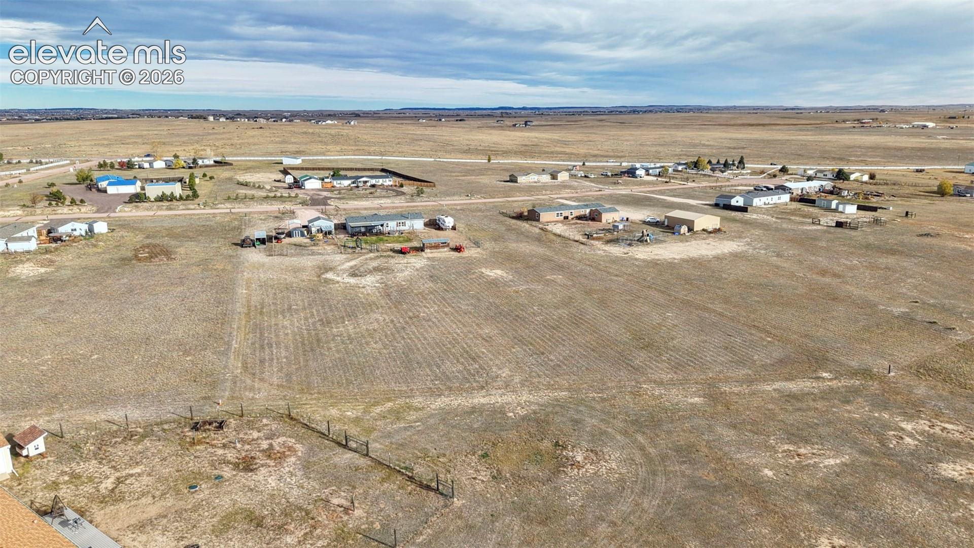 Expansive acreage featuring open terrain, wire fencing, and level topography