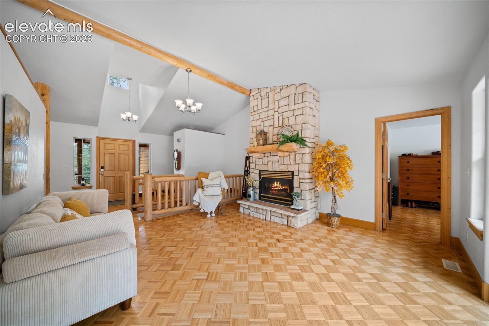 Main level living room with floor to ceiling stone fireplace