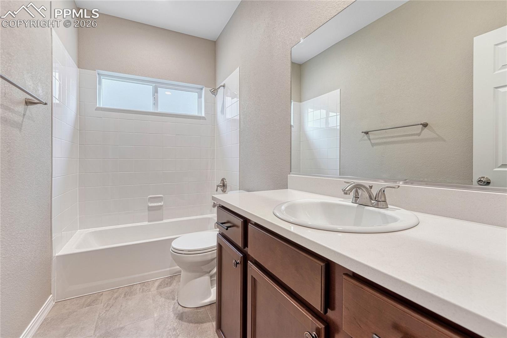 A full bathroom serves the secondary bedrooms. Your choice of finishes with undermount sink and tiled shower tub.