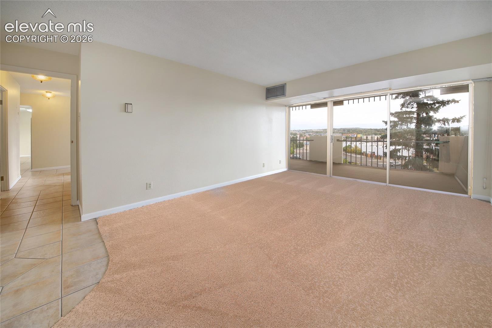 Spacious Primary Bedroom with attached bath, walk-in closet and new carpet.