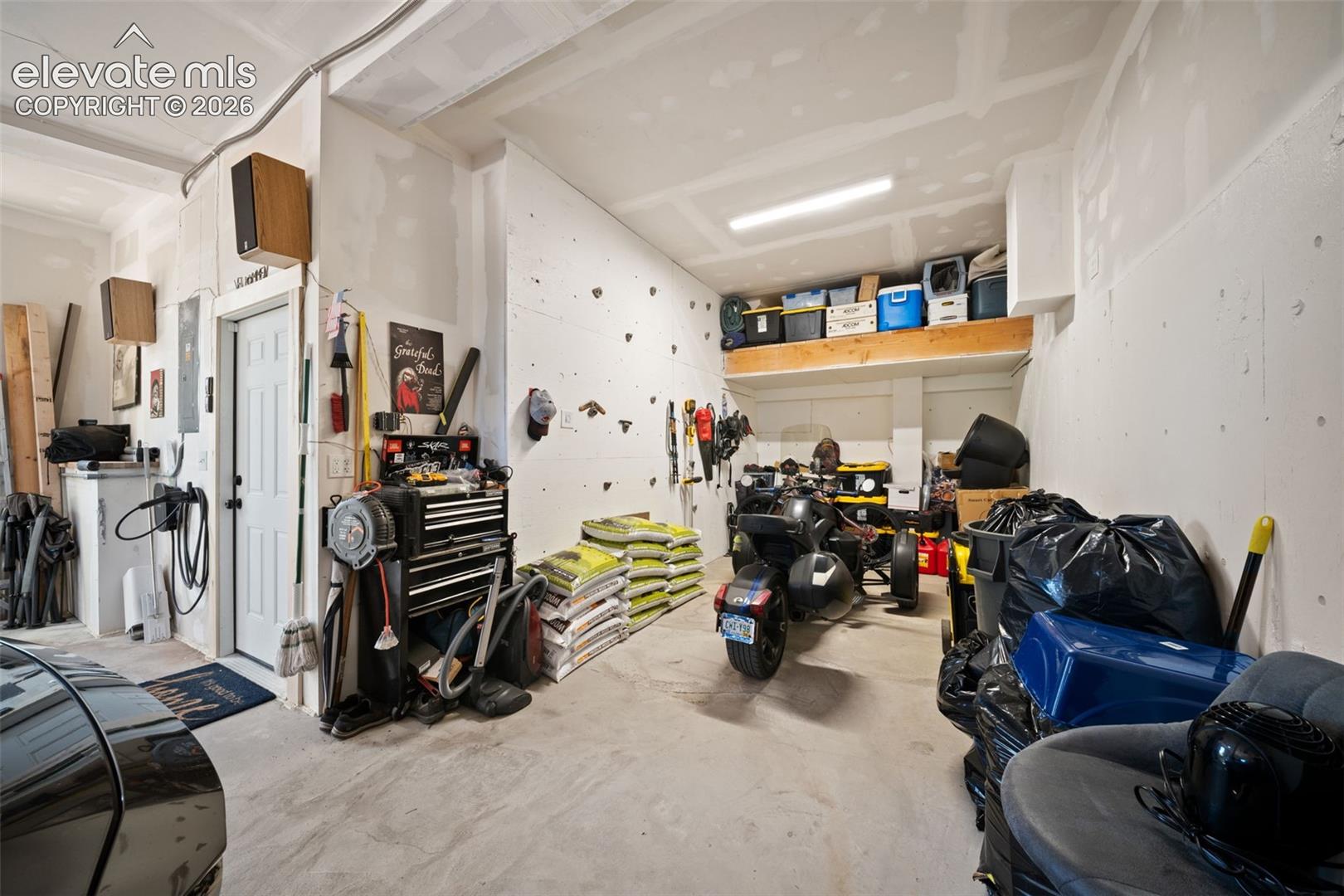 3 car attached heated tandem garage with storage and rock climbing wall