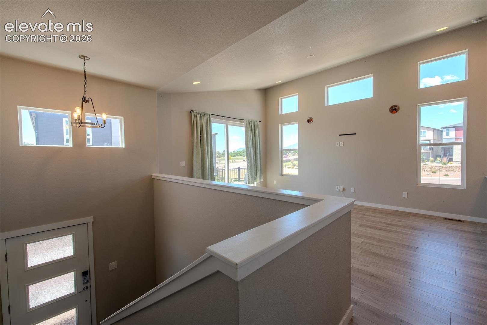 Light and bright Living Room/Dining Room with beautiful LVP flooring and sliding door to an upper composite balcony.