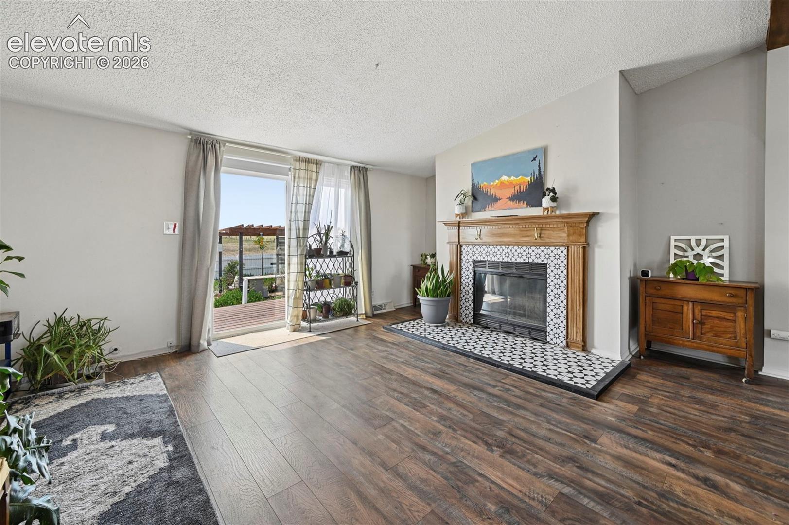 Dining area with Walk out to Backyard Deck and Beautifully Tiled Wood Burning Fireplace