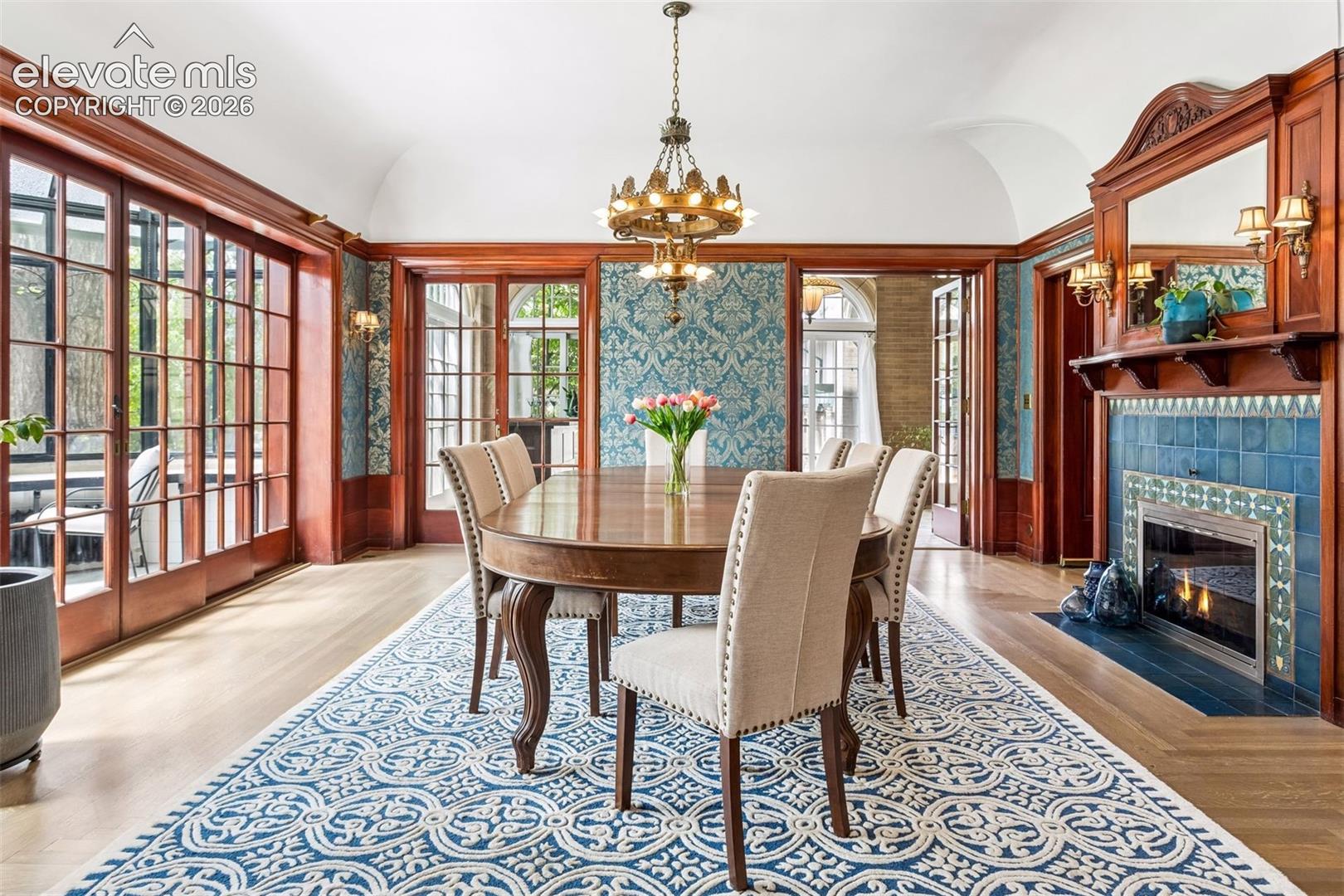 African mahogany wainscoted walls, original tapestry wallpaper, green Van Briggle tiles.