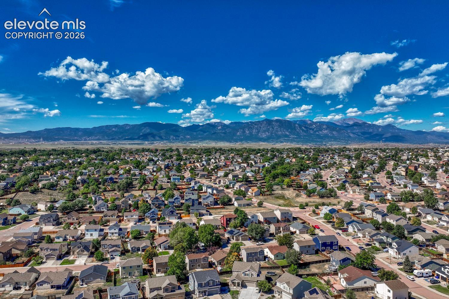 Aerial view of community and surrounding mountains.